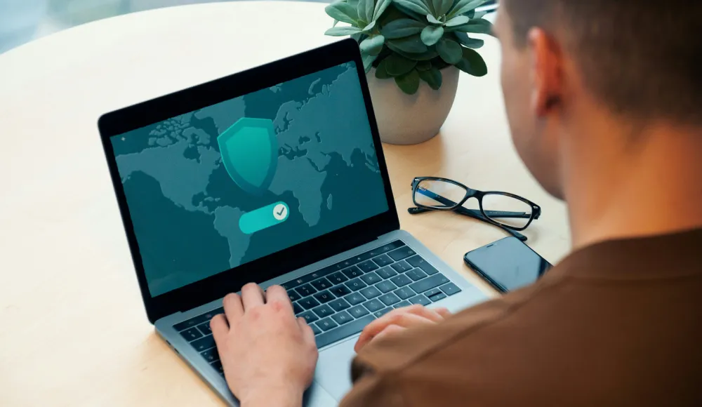 Person using laptop for cybersecurity threat prevention